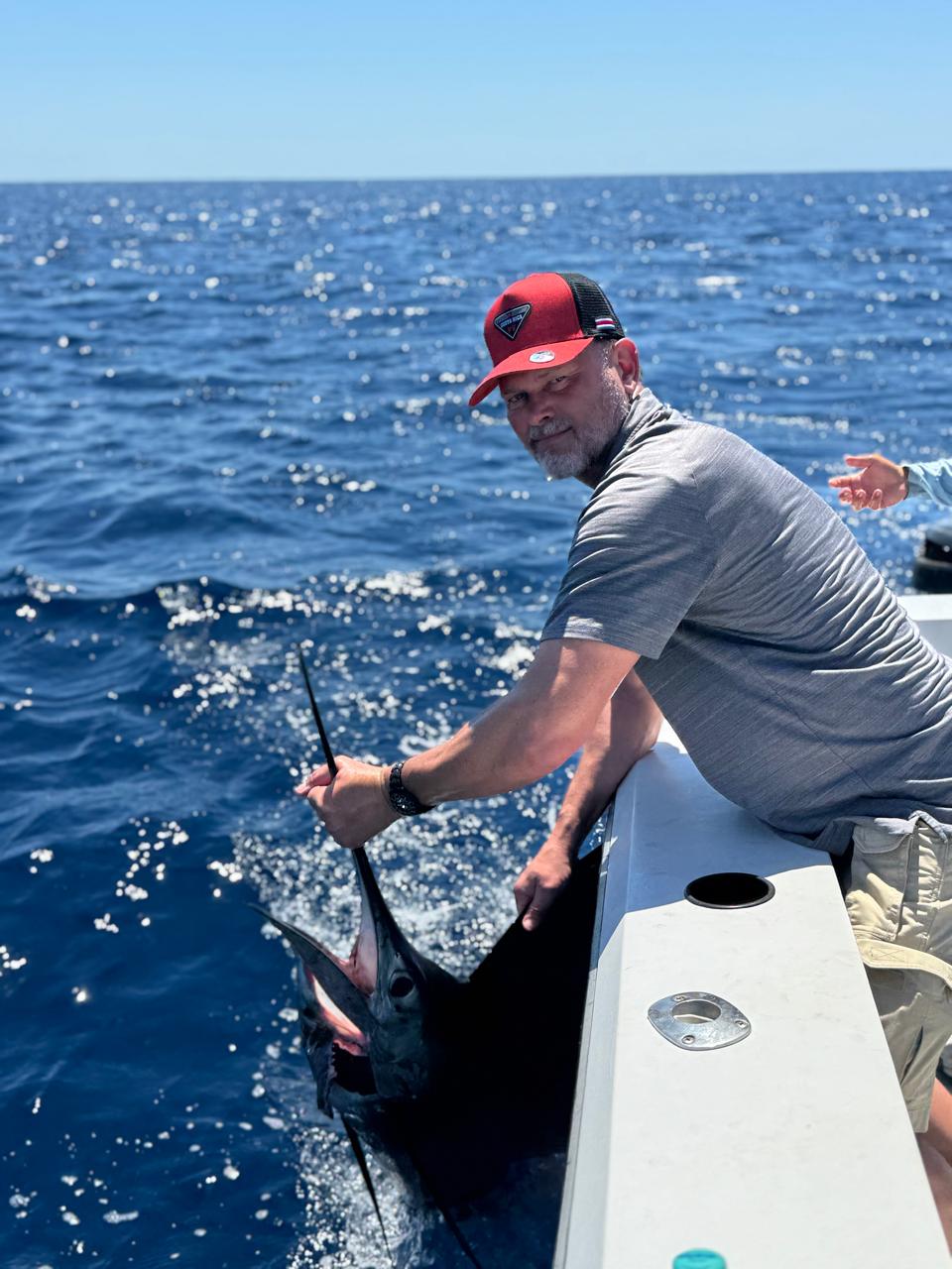 Angler releasing a marlin boatside
